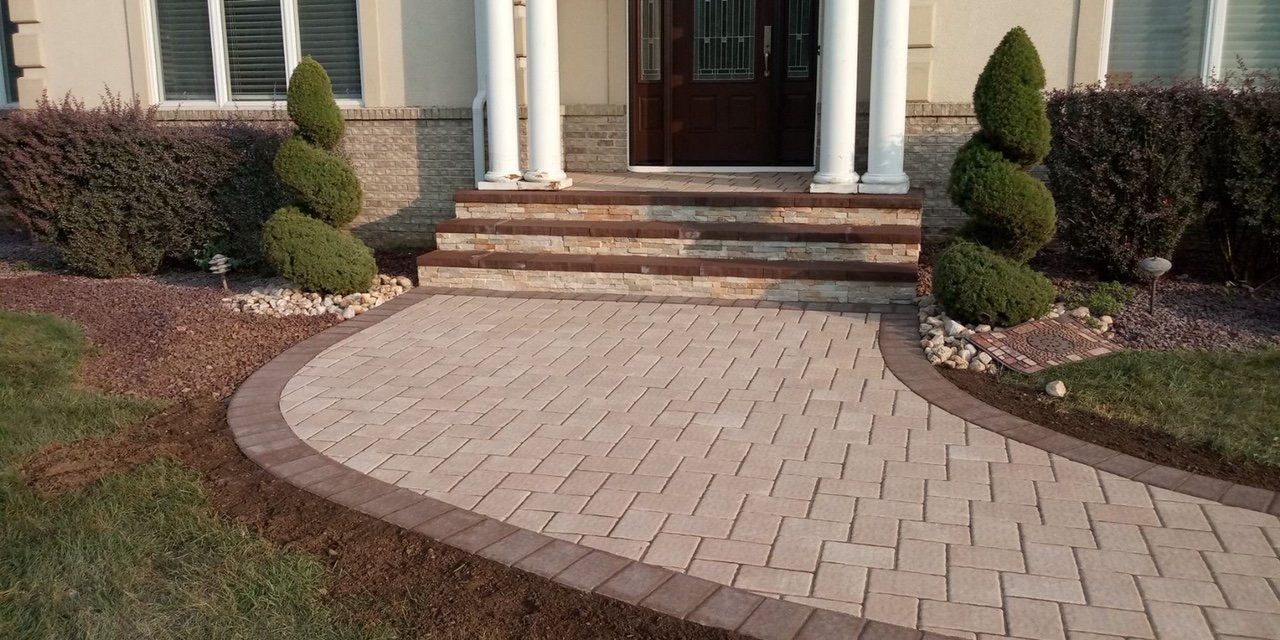 Curved paver entrance meeting front steps