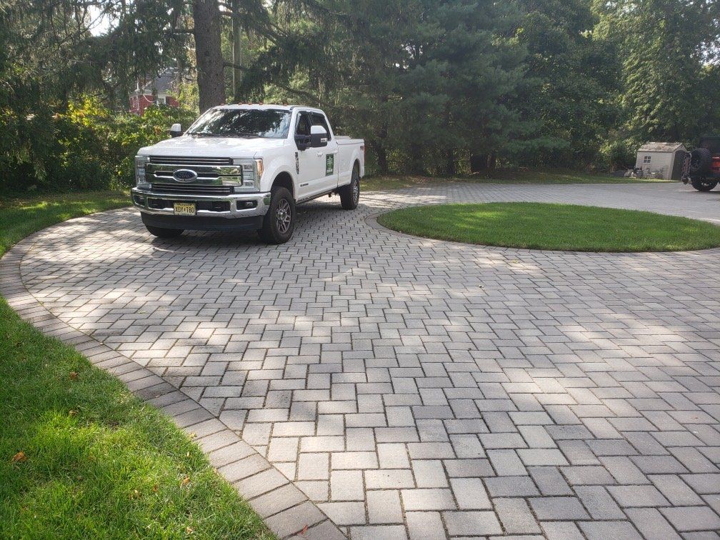 Curved gray paver driveway at a Central New Jersey home