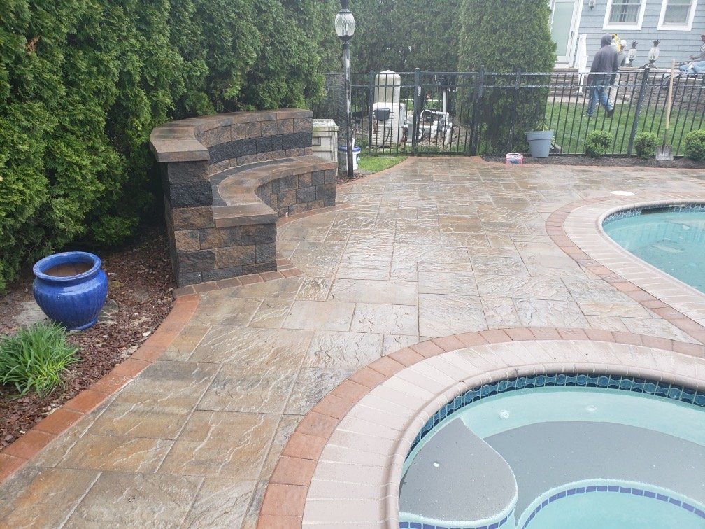 Pool deck with spa coping and a curved sitting wall