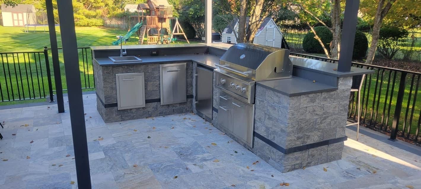 Stone outdoor kitchen with a built-in grill