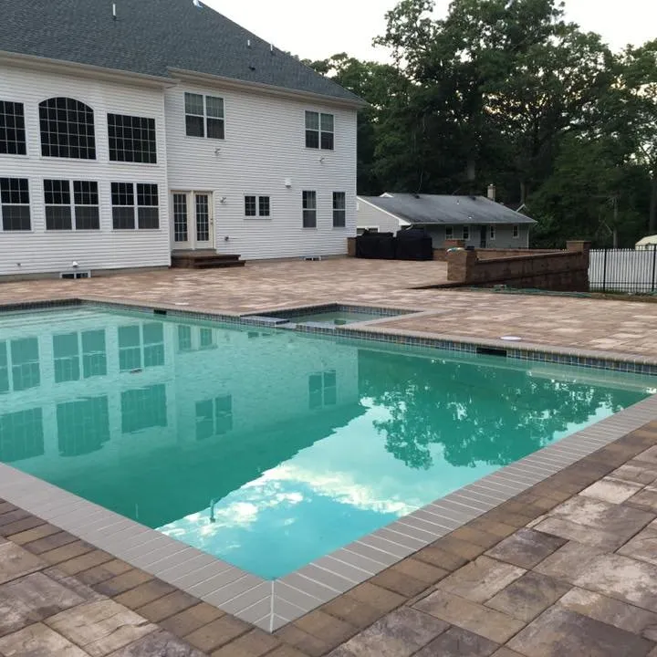 Contrasting pool coping following straight edges and corners