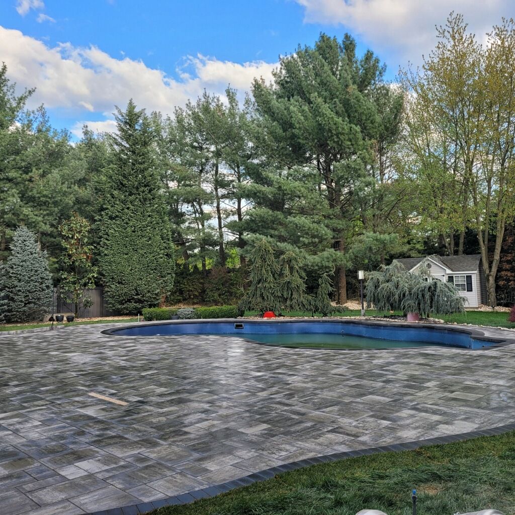 Swimming pool surrounded by a coordinated paver deck