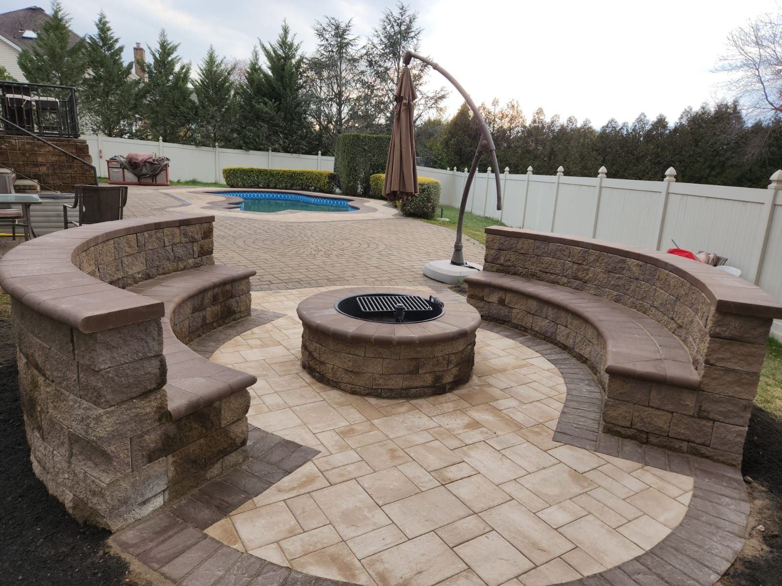 Curved stone sitting wall beside a patio