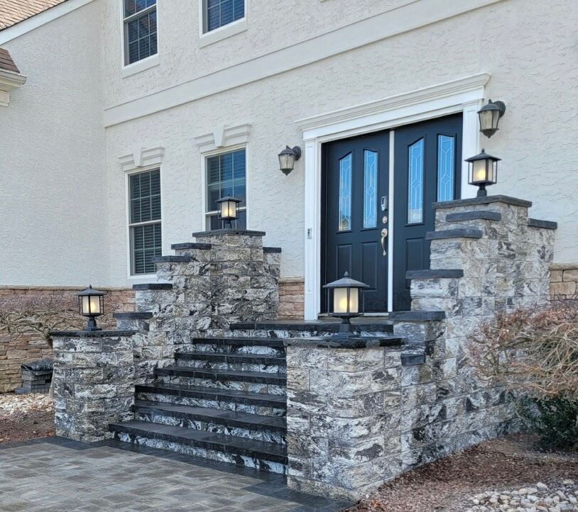 Stone front steps and wall lights at a New Jersey Pavers project